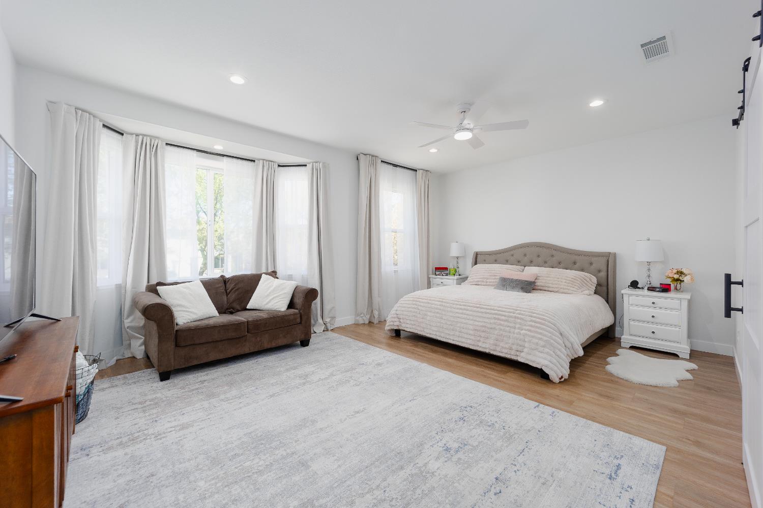 10969 Pelara Way Rancho Cordova, CA 95670 - Photo 19 of 39 a spacious bedroom with a bed couch and a window