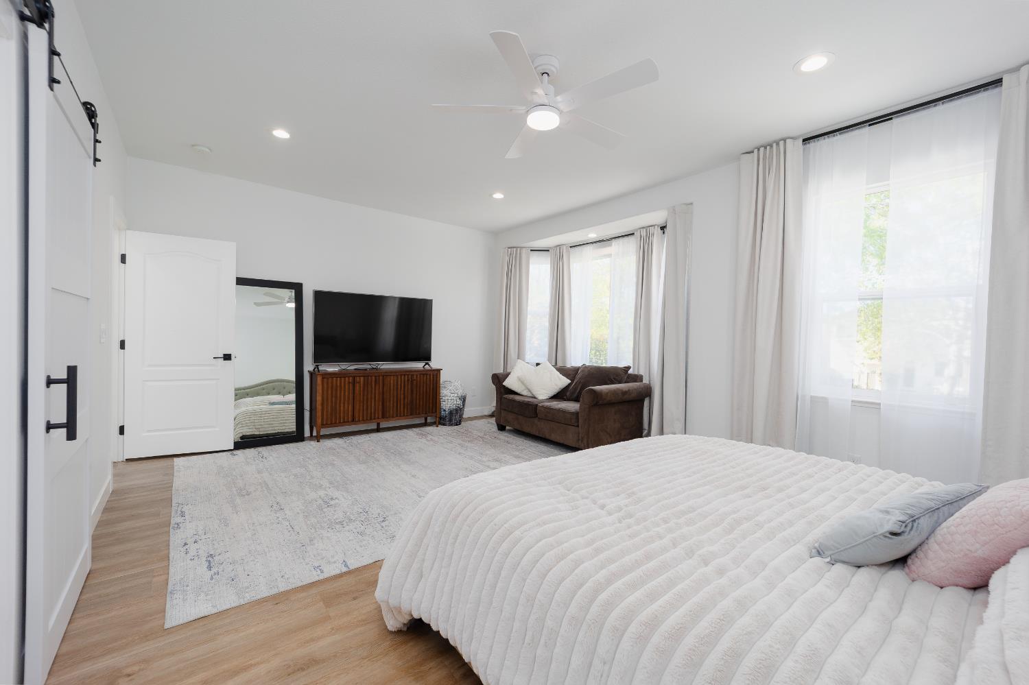 10969 Pelara Way Rancho Cordova, CA 95670 - Photo 21 of 39 a spacious bedroom with a bed and a flat screen tv