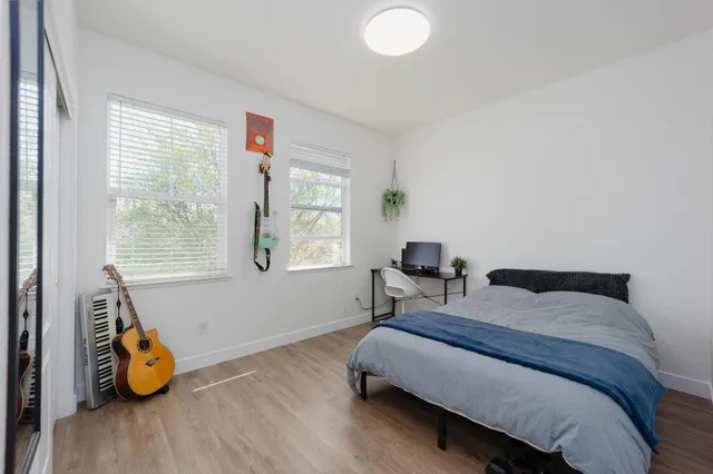 a bedroom with a bed and a window