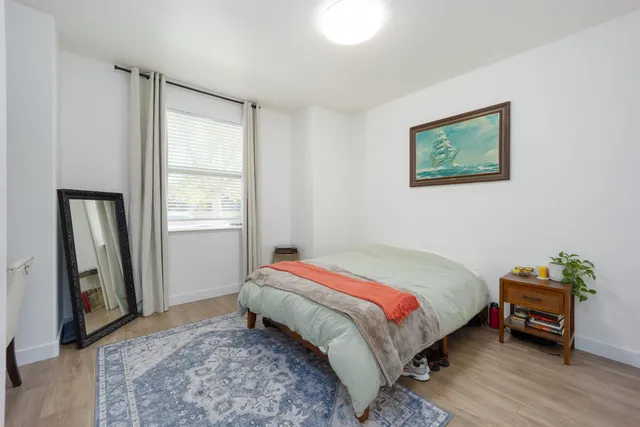 a bedroom with a bed and a window