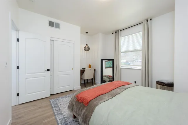 a bedroom with a bed and a window