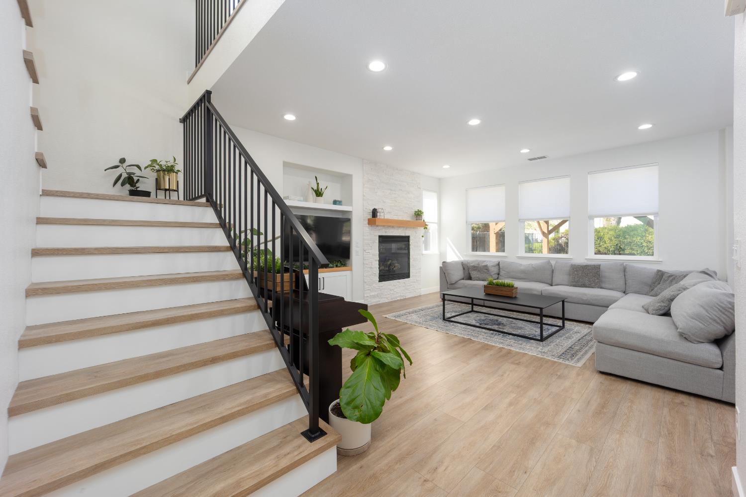 10969 Pelara Way Rancho Cordova, CA 95670 - Photo 3 of 39 a living room with furniture and a dining table with wooden floor