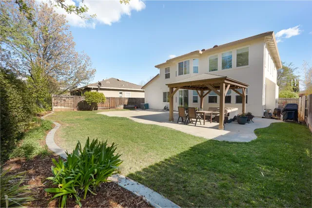 a house view with swimming pool and garden space