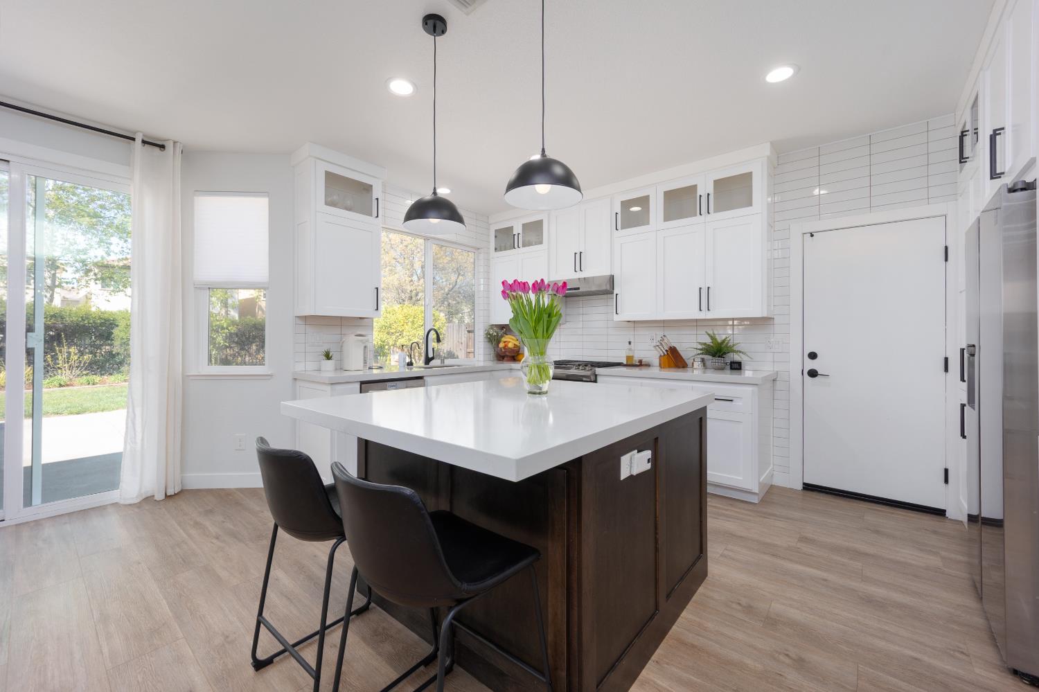 10969 Pelara Way Rancho Cordova, CA 95670 - Photo 10 of 39 a kitchen with a sink a refrigerator and wooden floor