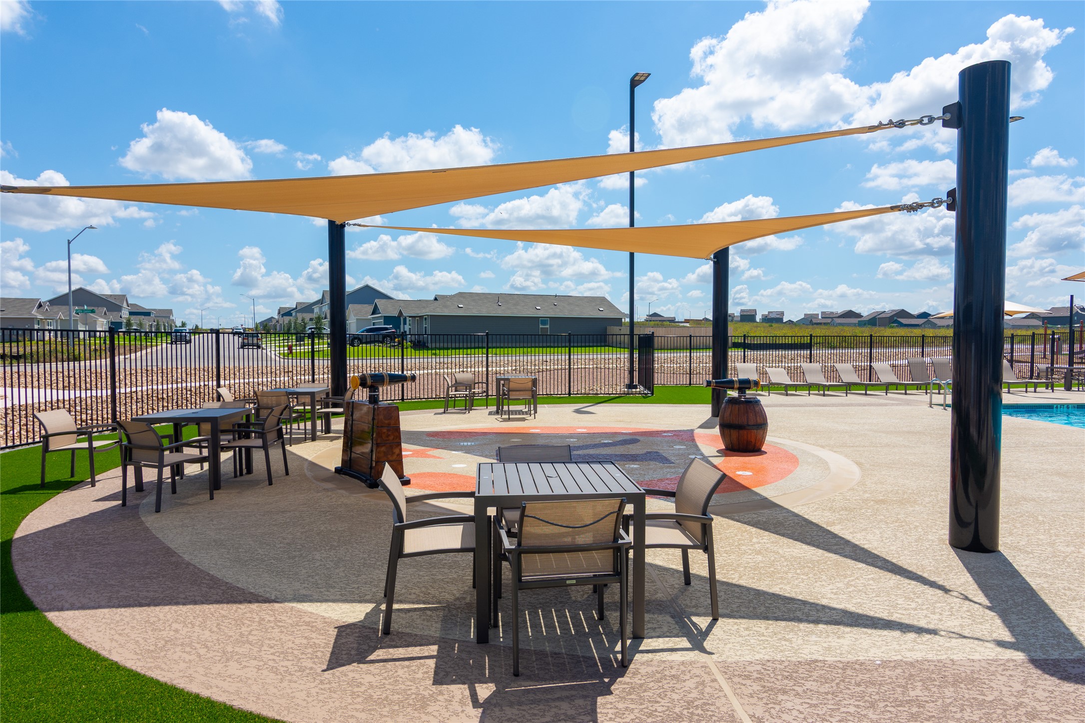 548 Rancho Del Cielo Loop Jarrell, TX 76537 - Photo 35 of 40 Outdoor amenity area featuring multiple shade sails, aggregate paving, and artificial turf