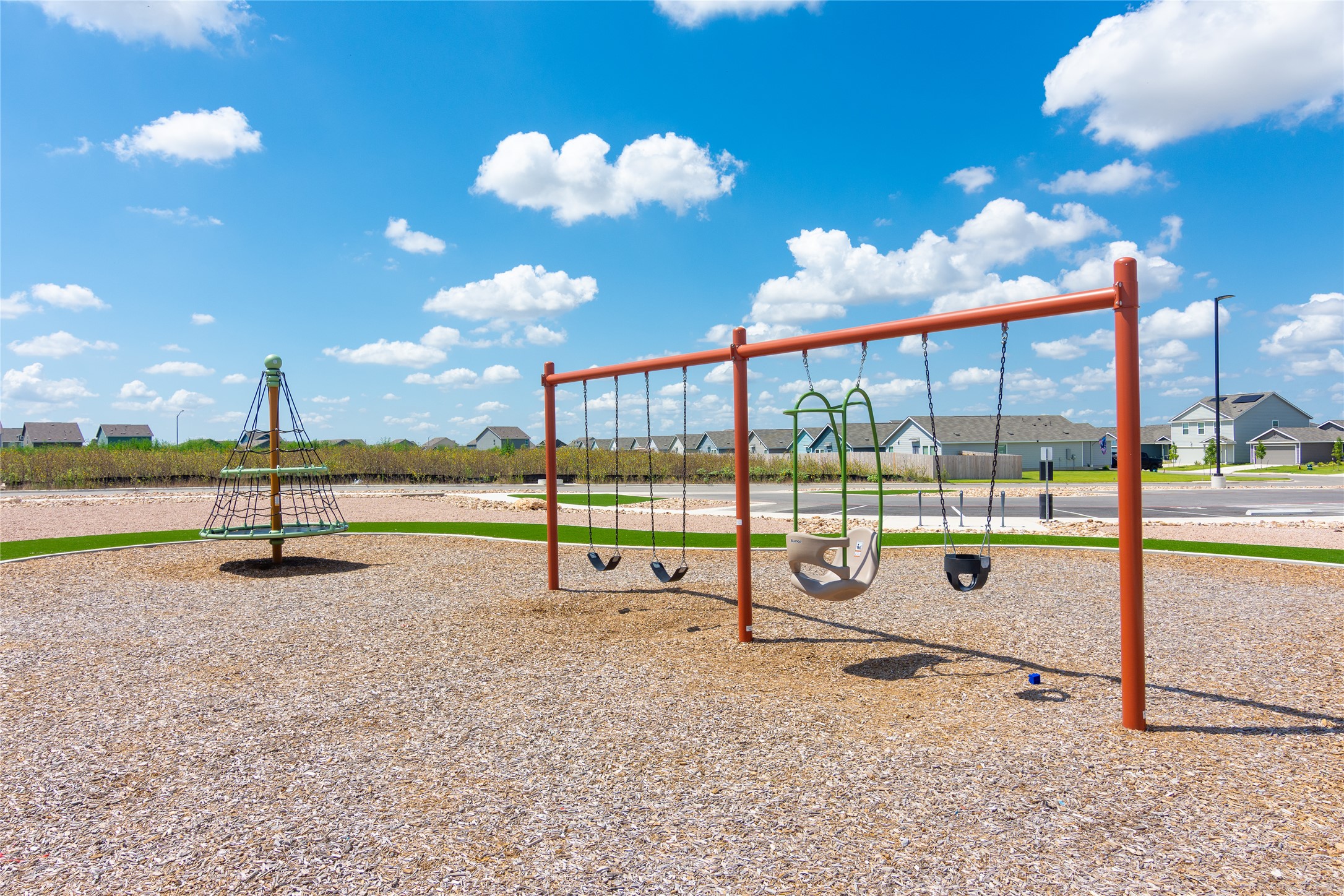 548 Rancho Del Cielo Loop Jarrell, TX 76537 - Photo 37 of 40 Recreational park area featuring a swing set with multiple swings and a climbing net structure