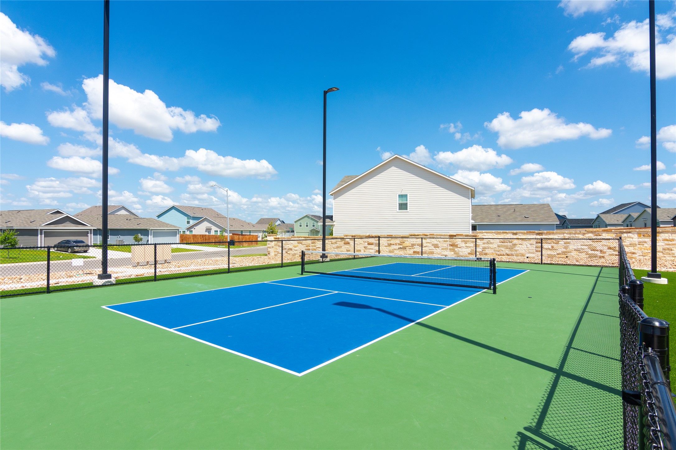 548 Rancho Del Cielo Loop Jarrell, TX 76537 - Photo 39 of 40 Outdoor recreational court featuring a blue playing surface with green surrounds