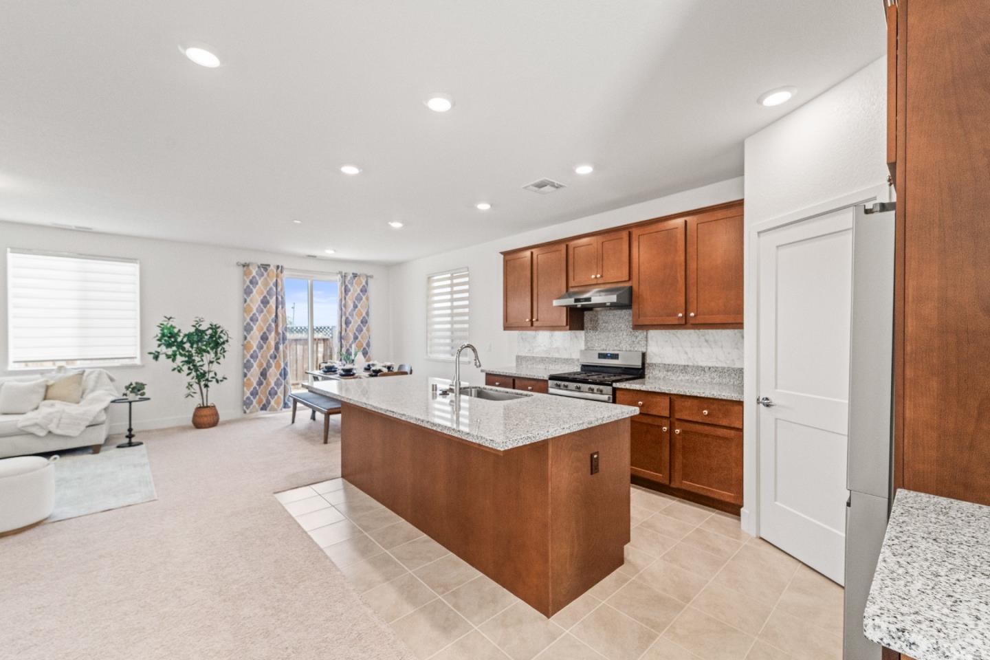 384 Ramos Ranch Road Oakley, CA 94561 - Photo 4 of 39 a large white kitchen with stainless steel appliances granite countertop a lot of counter space and a sink