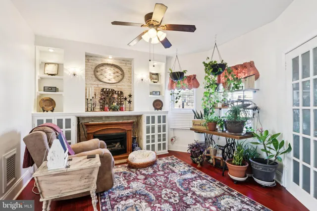 a living room with furniture a potted plant and a fireplace