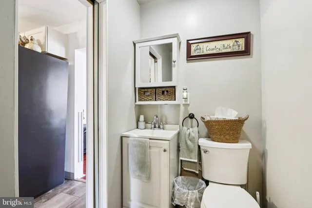 a white toilet sitting next to a bathroom sink