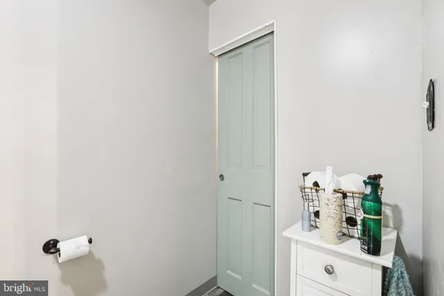 a room with white cabinets and wooden floor