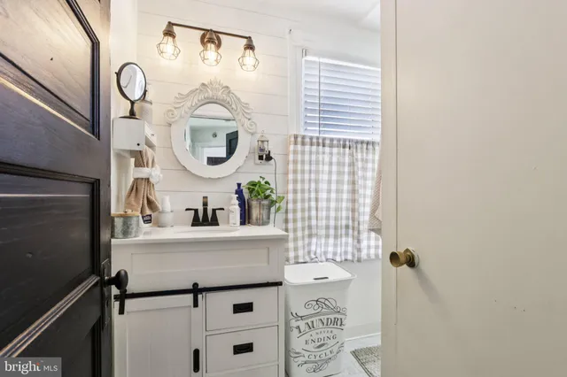 a bedroom with a bed and a night stand