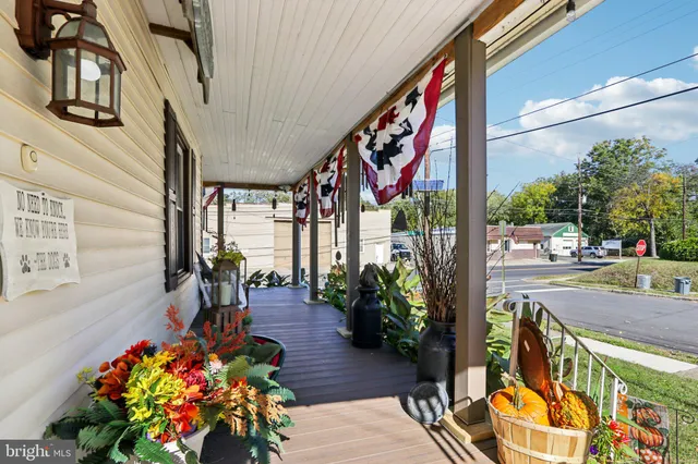 a street view with tall buildings and a yard