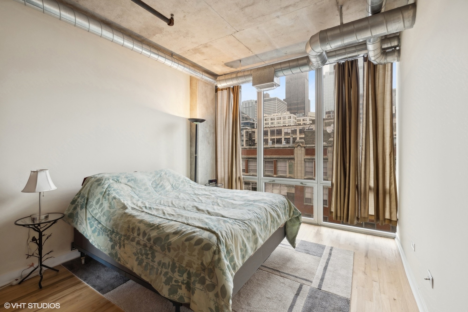 700 West Van Buren Street, Unit 1002 Chicago, IL 60607 - Photo 13 of 18 a bedroom with a bed and a window