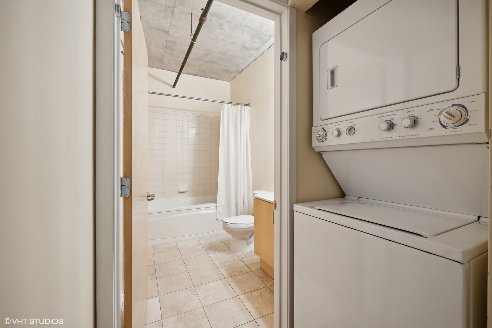 700 West Van Buren Street, Unit 1002 Chicago, IL 60607 - Photo 16 of 18 a view of washer and dryer with bathroom in the background