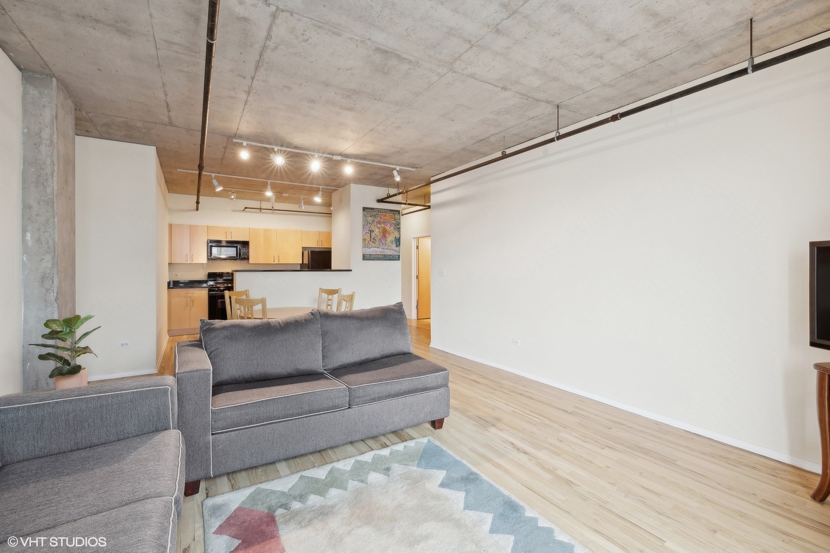 700 West Van Buren Street, Unit 1002 Chicago, IL 60607 - Photo 4 of 18 a living room with furniture and a chandelier