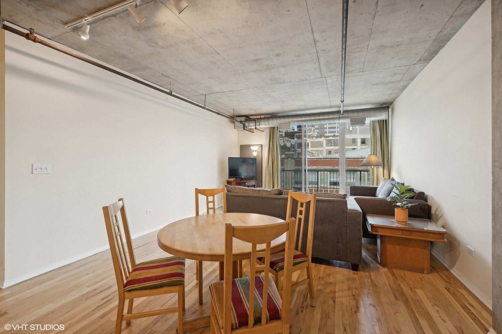 700 West Van Buren Street, Unit 1002 Chicago, IL 60607 - Photo 6 of 18 a dining room with furniture and wooden floor