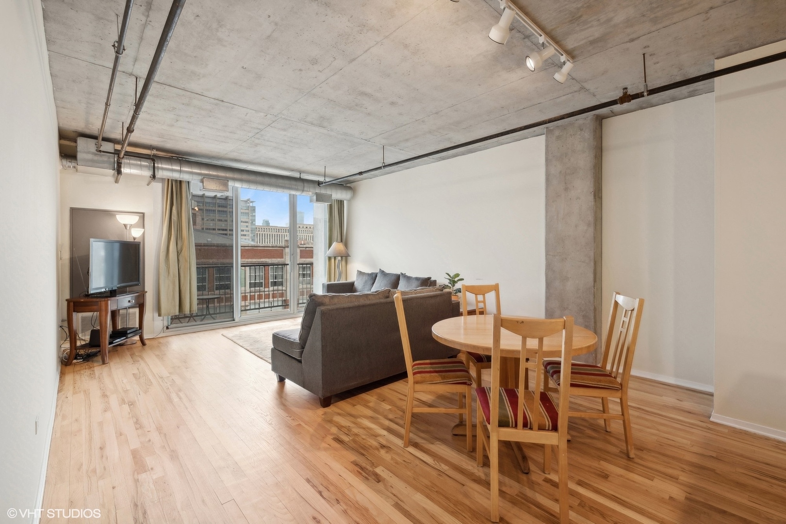 700 West Van Buren Street, Unit 1002 Chicago, IL 60607 - Photo 7 of 18 a dining room with furniture and wooden floor