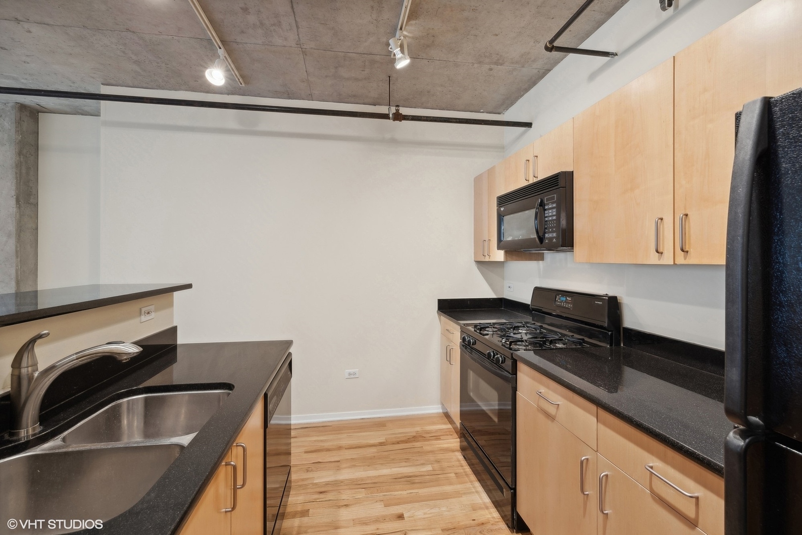 700 West Van Buren Street, Unit 1002 Chicago, IL 60607 - Photo 8 of 18 a kitchen with stainless steel appliances granite countertop a sink stove and refrigerator