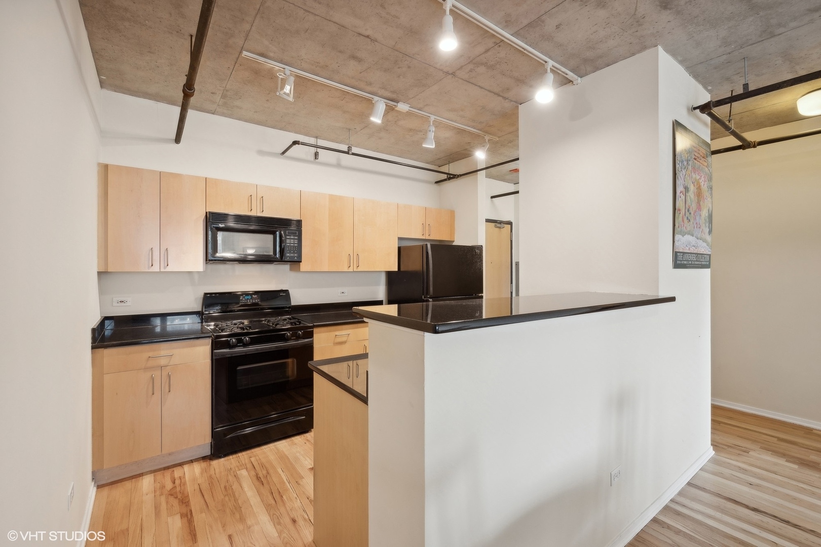 700 West Van Buren Street, Unit 1002 Chicago, IL 60607 - Photo 9 of 18 a kitchen with stainless steel appliances a refrigerator stove and microwave