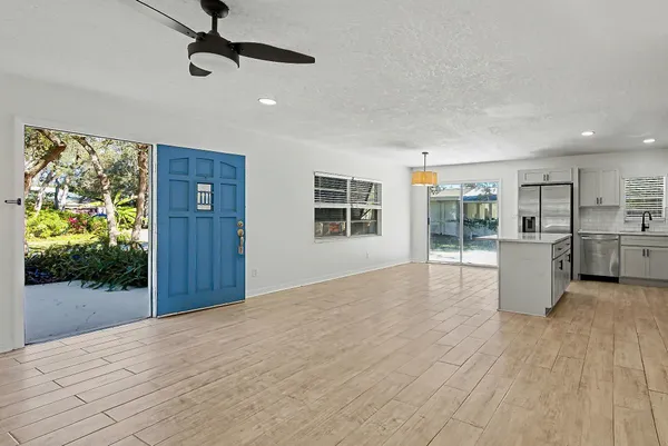 a view of empty room with wooden floor and windows