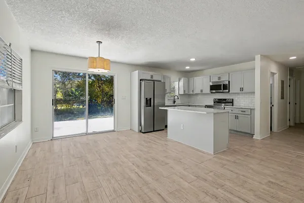 a kitchen with stainless steel appliances a refrigerator sink and cabinets