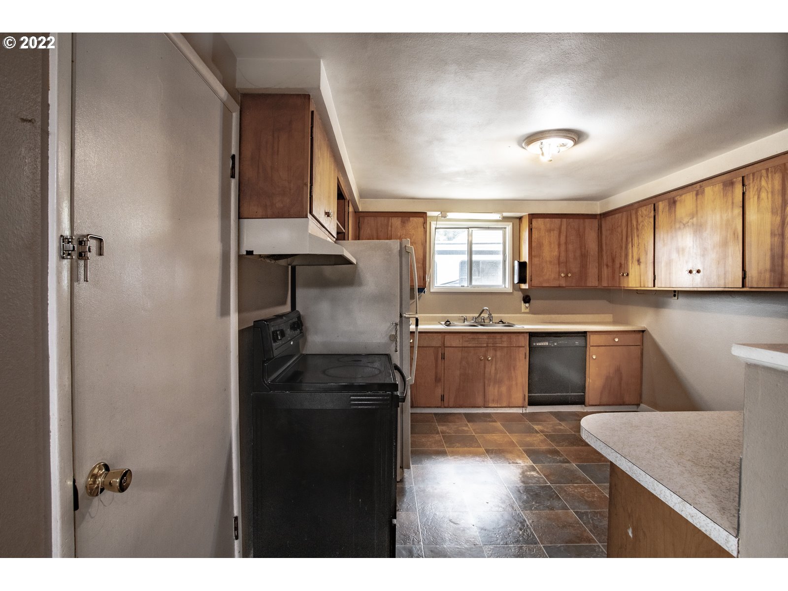 2364 G Street Springfield, OR 97477 - Photo 9 of 15 a kitchen with kitchen island granite countertop a sink cabinets and stainless steel appliances