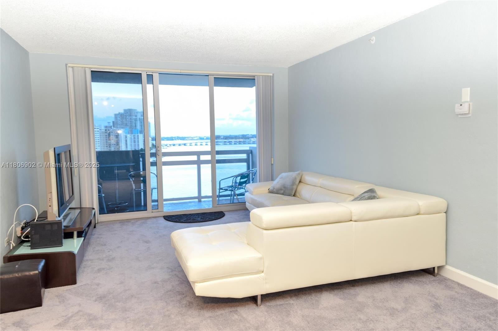 1500 Bay Road, Unit 1532S Miami Beach, FL 33139 - Photo 11 of 50 a living room with furniture and a window