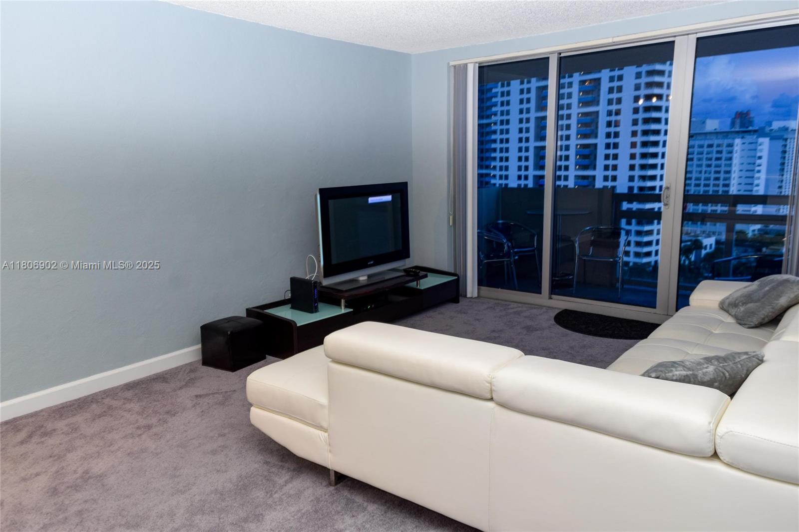 1500 Bay Road, Unit 1532S Miami Beach, FL 33139 - Photo 14 of 50 a living room with furniture and a flat screen tv