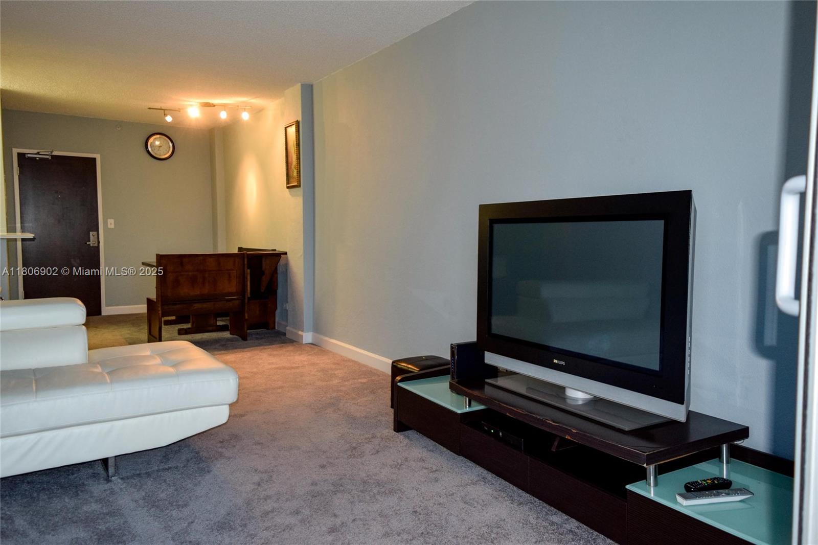 1500 Bay Road, Unit 1532S Miami Beach, FL 33139 - Photo 15 of 50 a living room with furniture and a flat screen tv