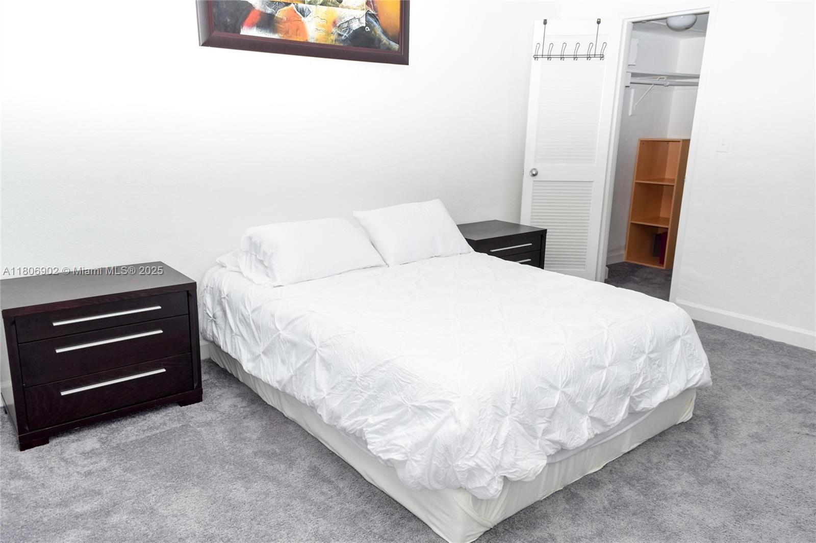 1500 Bay Road, Unit 1532S Miami Beach, FL 33139 - Photo 21 of 50 a large bed sitting in a bedroom next to a window