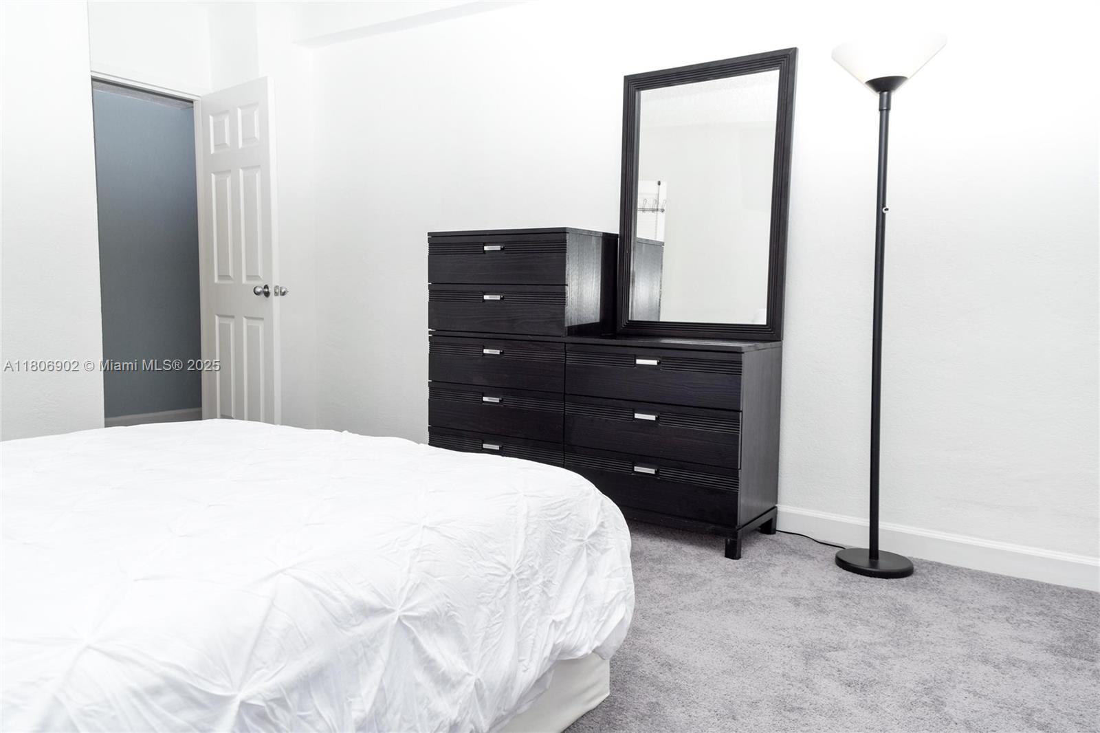 1500 Bay Road, Unit 1532S Miami Beach, FL 33139 - Photo 22 of 50 a bedroom with a bed and a dresser