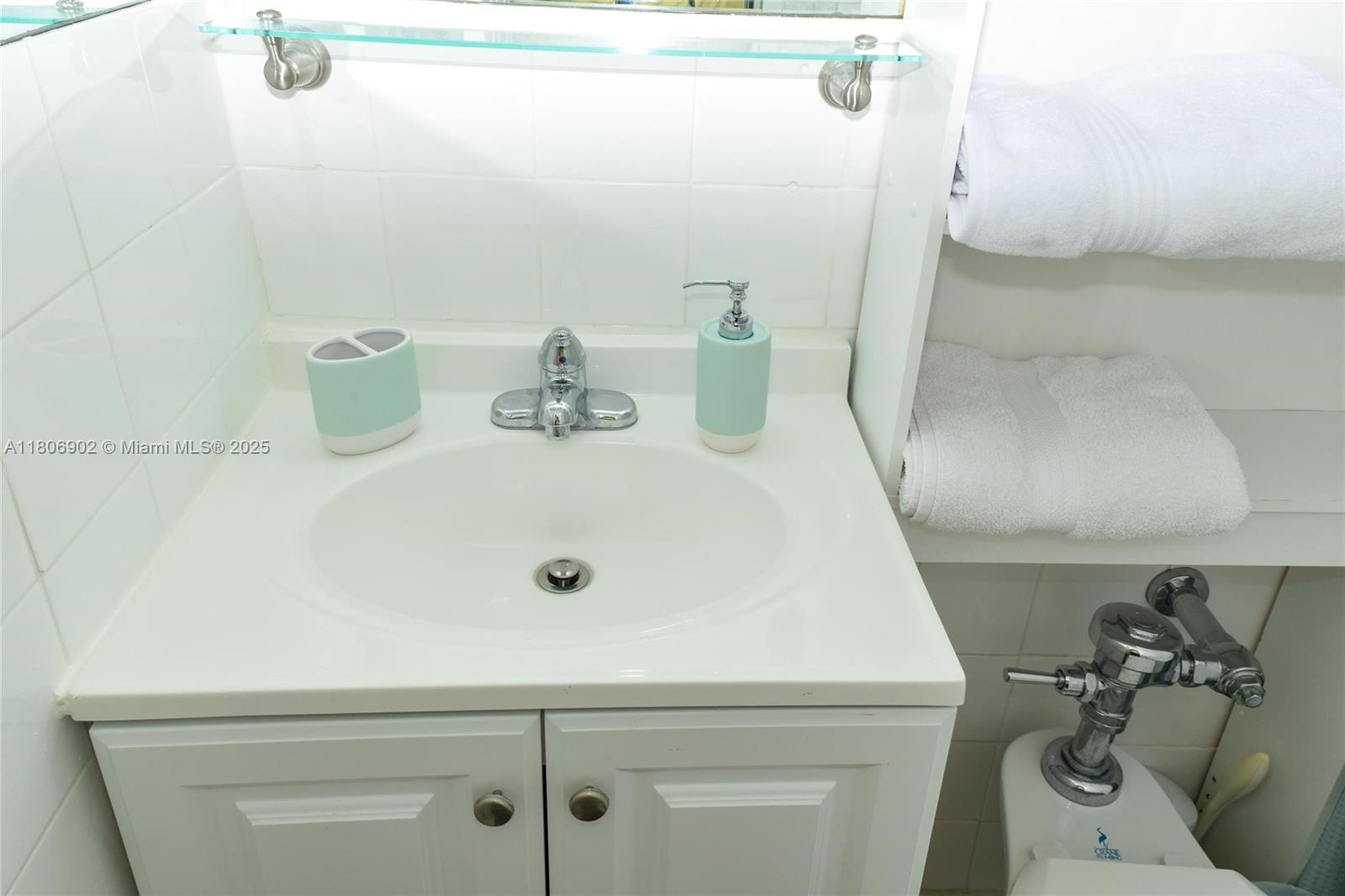 1500 Bay Road, Unit 1532S Miami Beach, FL 33139 - Photo 23 of 50 a bathroom with a sink and a mirror