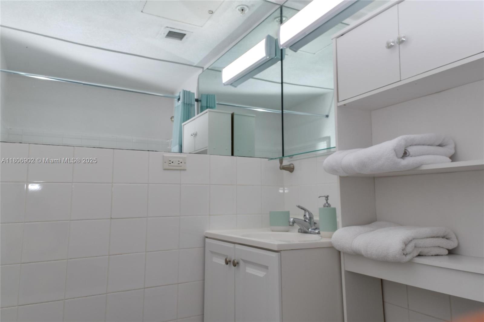 1500 Bay Road, Unit 1532S Miami Beach, FL 33139 - Photo 25 of 50 a bathroom with a sink and mirror