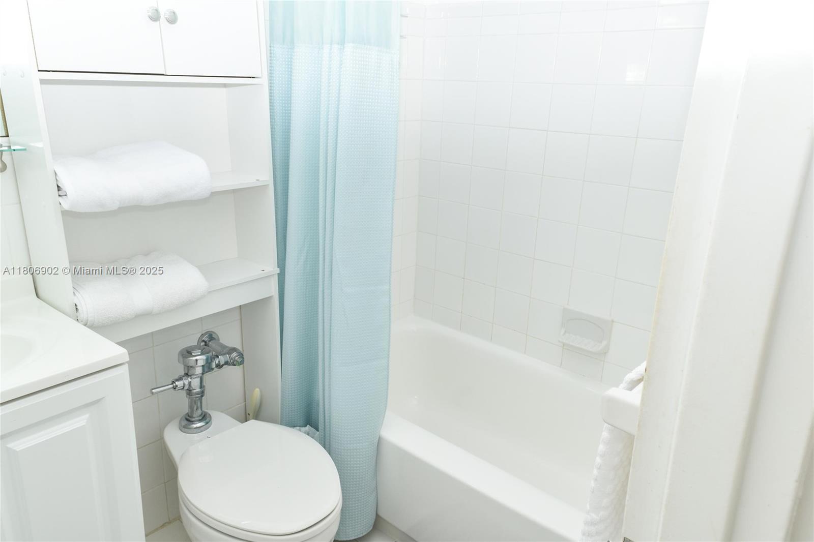 1500 Bay Road, Unit 1532S Miami Beach, FL 33139 - Photo 26 of 50 a white toilet sitting next to a bathroom sink and tub