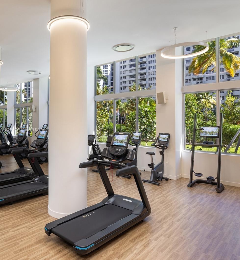 1500 Bay Road, Unit 1532S Miami Beach, FL 33139 - Photo 49 of 50 a room with gym equipment and a large window