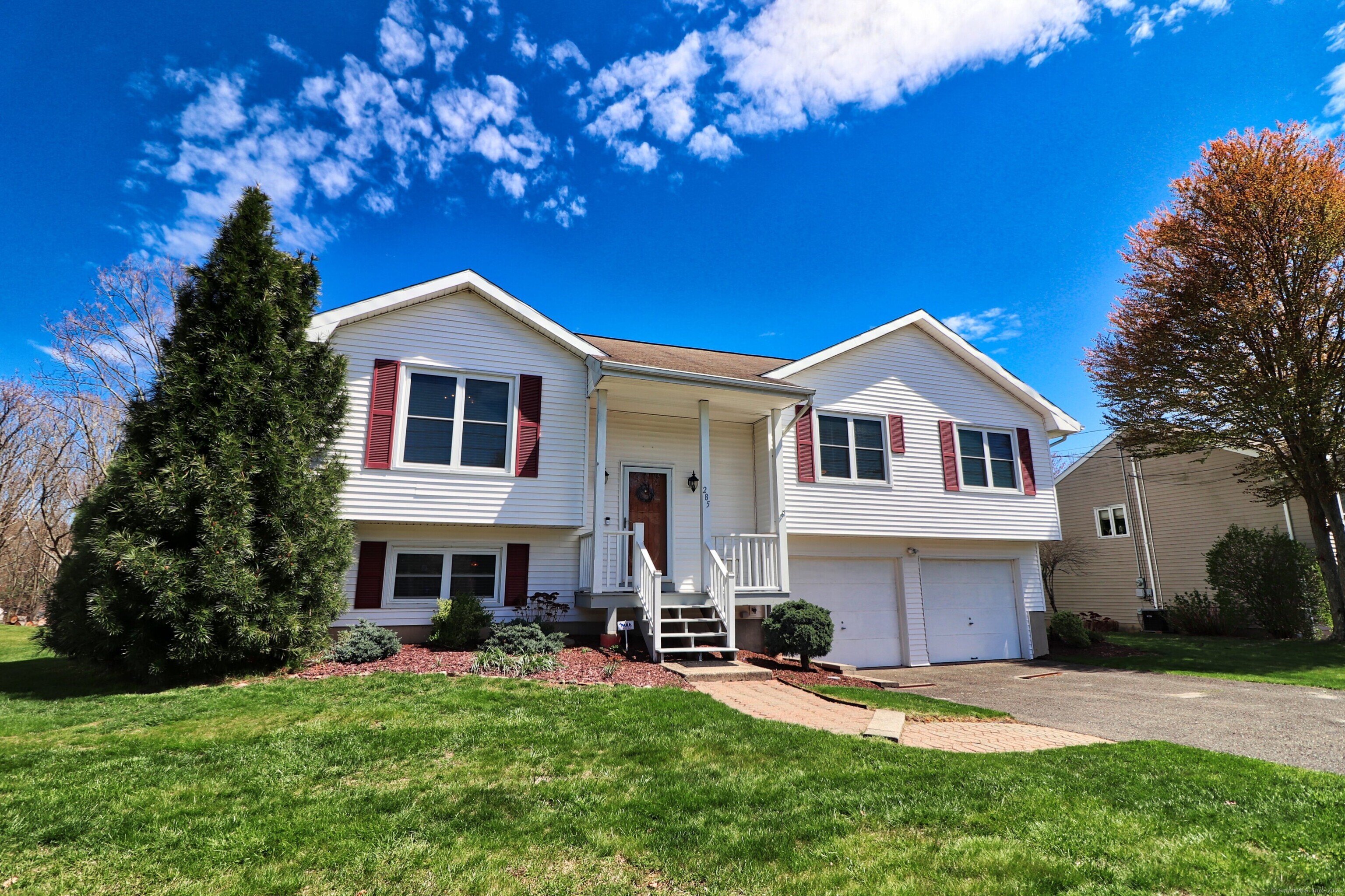 a front view of a house with a garden and porch