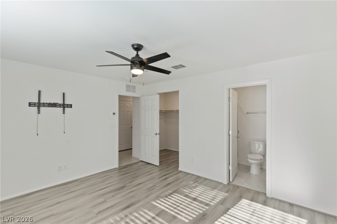 6227 Runestone Street Las Vegas, NV 89113 - Photo 13 of 33 Bright and airy living space featuring modern flooring and ample natural light.