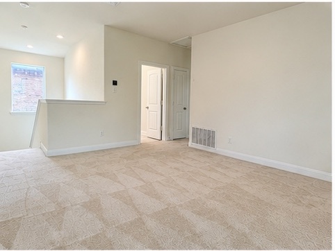 2101 Split Diamond Way, Unit 40 Round Rock, TX 78664 - Photo 18 of 32 A well-lit, open-concept bonus room offers versatile living space and a window view.