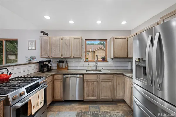a kitchen with a sink stove and refrigerator