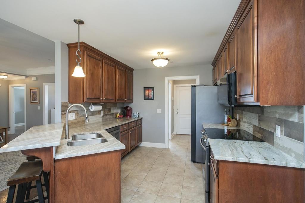 110 Edgewater Falls Murfreesboro, TN 37129 - Photo 13 of 31 a kitchen with stainless steel appliances granite countertop a sink refrigerator and cabinets