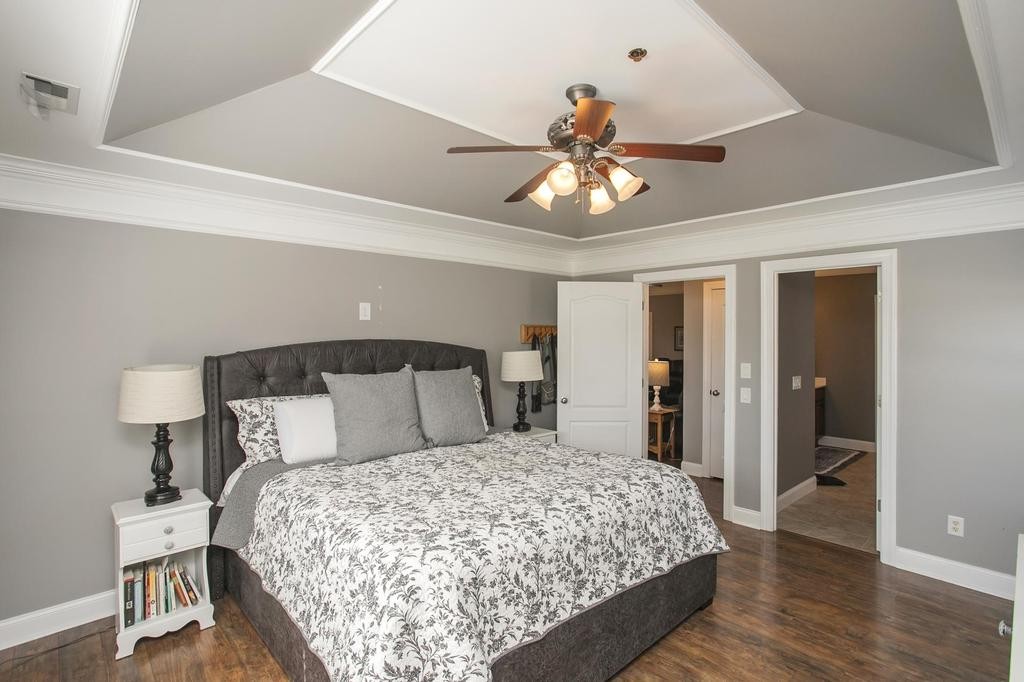 110 Edgewater Falls Murfreesboro, TN 37129 - Photo 6 of 31 a bedroom with a large bed and a chandelier