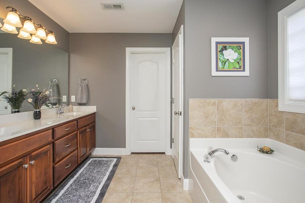 110 Edgewater Falls Murfreesboro, TN 37129 - Photo 7 of 31 a bathroom with a tub sink and mirror