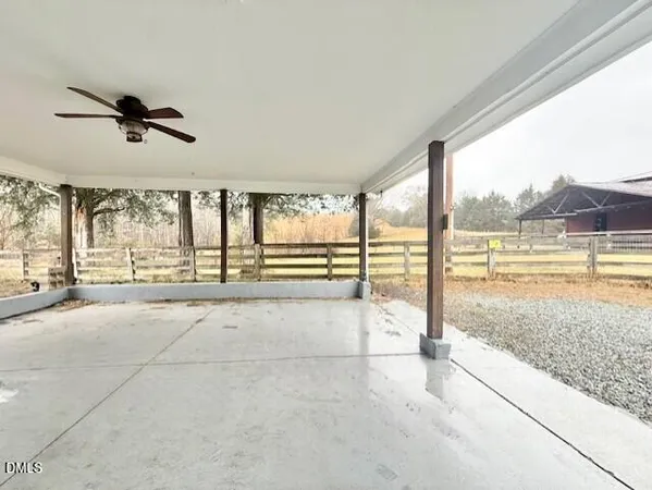 a view of an empty room with a floor to ceiling window and an outdoor view
