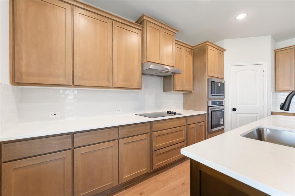 30 Roosevelt Ln Valley View Valley View, TX 76272 - Photo 21 of 35 a kitchen with white cabinets and sink