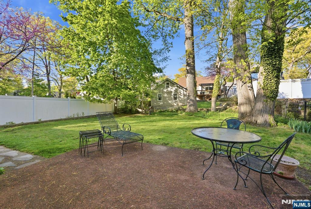 34 Espy Road Caldwell, NJ 07006 - Photo 18 of 25 a view of a backyard with table and chairs plants and trees