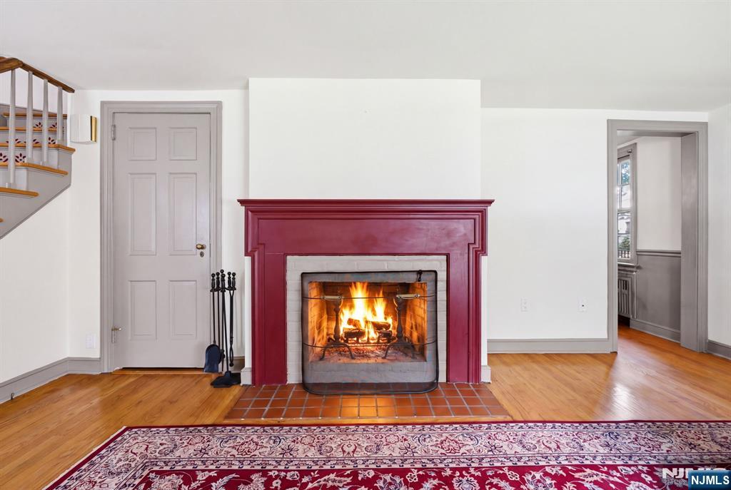 34 Espy Road Caldwell, NJ 07006 - Photo 6 of 25 a view of an empty room with wooden floor fireplace and a window
