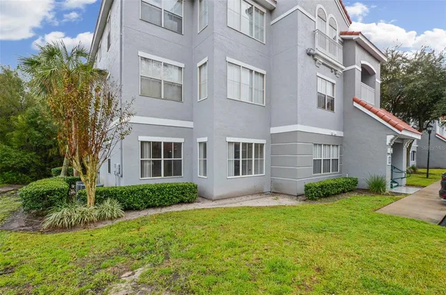 a view of backyard of house with green space