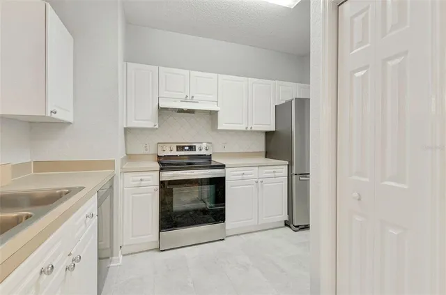 a kitchen with cabinets appliances and a sink