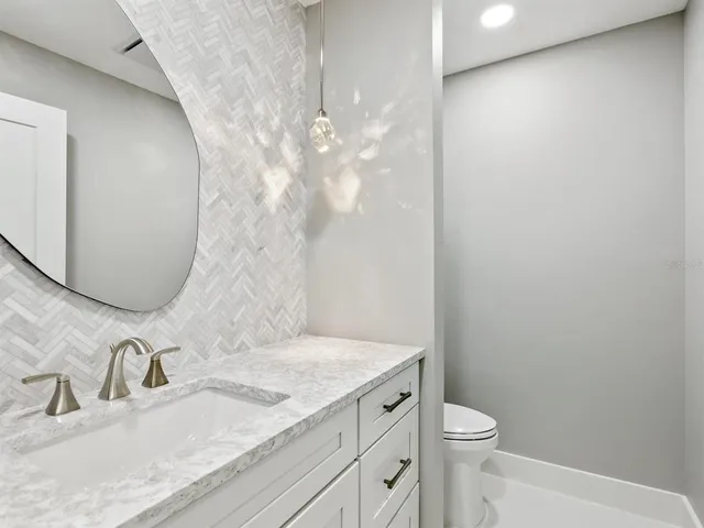 a view of garage with a table and chairs under an umbrella